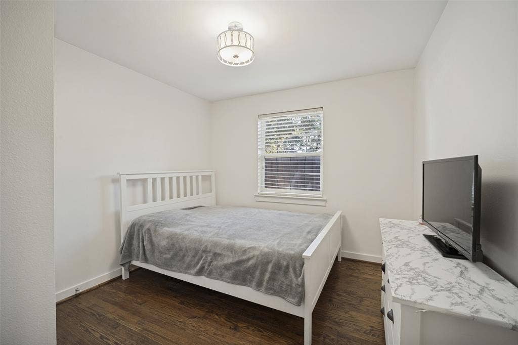 3209 Karla Drive, Mesquite, TX 75150 Recessed window with blinds, wood-finish flooring, white walls, and a semi-flush mount ceiling light