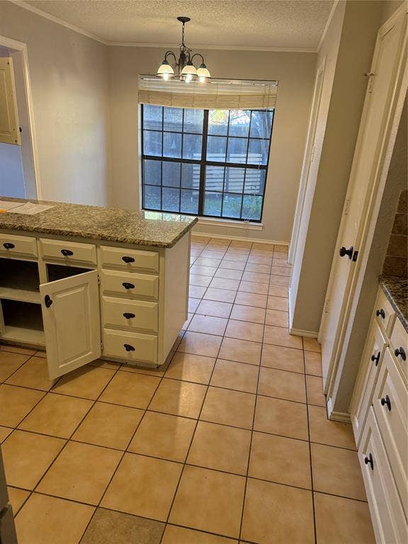 3407 Ruidoso Drive, Arlington, TX 76017 Functional kitchen island with a light-toned countertop, white cabinetry, and dark hardware
