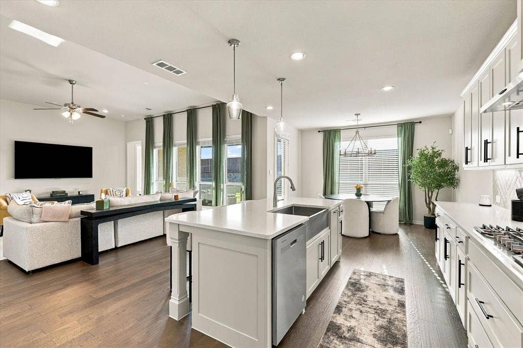 Open-concept living space with wood-finish flooring, recessed lighting, and a ceiling fan
