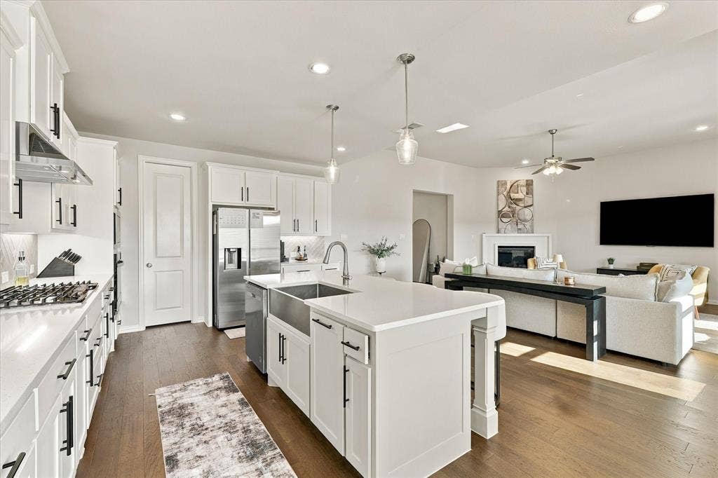 Kitchen island with countertop seating and a farmhouse sink