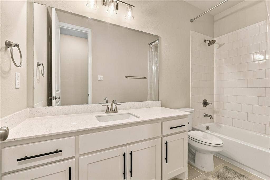 White subway tile surround with a built-in bathtub