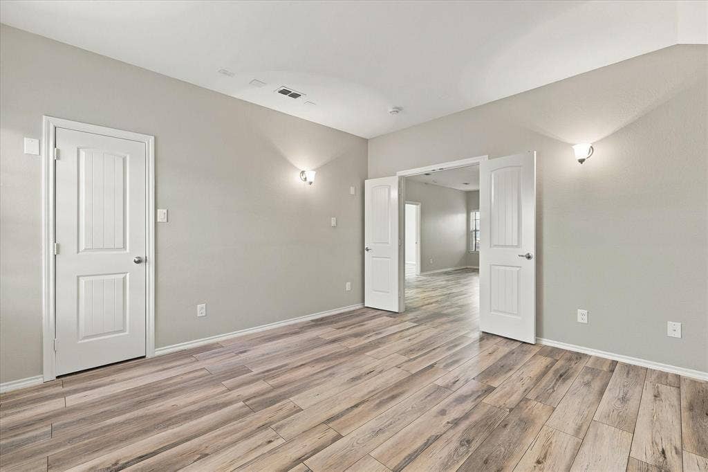 4716 Kendrick Peak Way, Fort Worth, TX 76244 Wood-finish flooring, light gray wall tones, and white trim