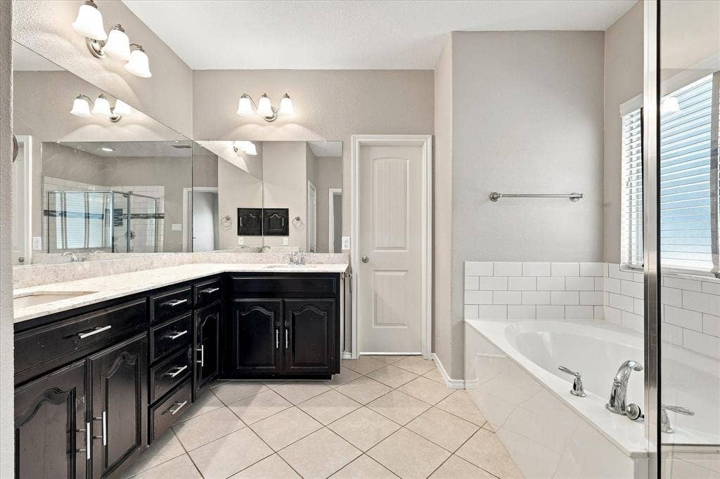 4716 Kendrick Peak Way, Fort Worth, TX 76244 Dual vanity with dark wood-finish cabinetry and light-toned countertops