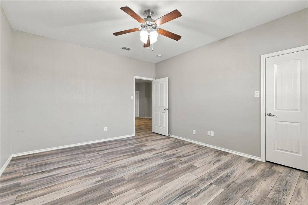 4716 Kendrick Peak Way, Fort Worth, TX 76244 Wood-finish flooring with a neutral paint palette and white trim