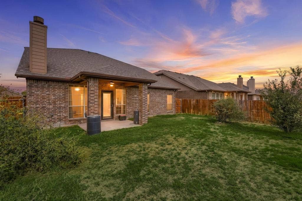 4716 Kendrick Peak Way, Fort Worth, TX 76244 Brick exterior with multiple windows, covered patio, and shingled roof