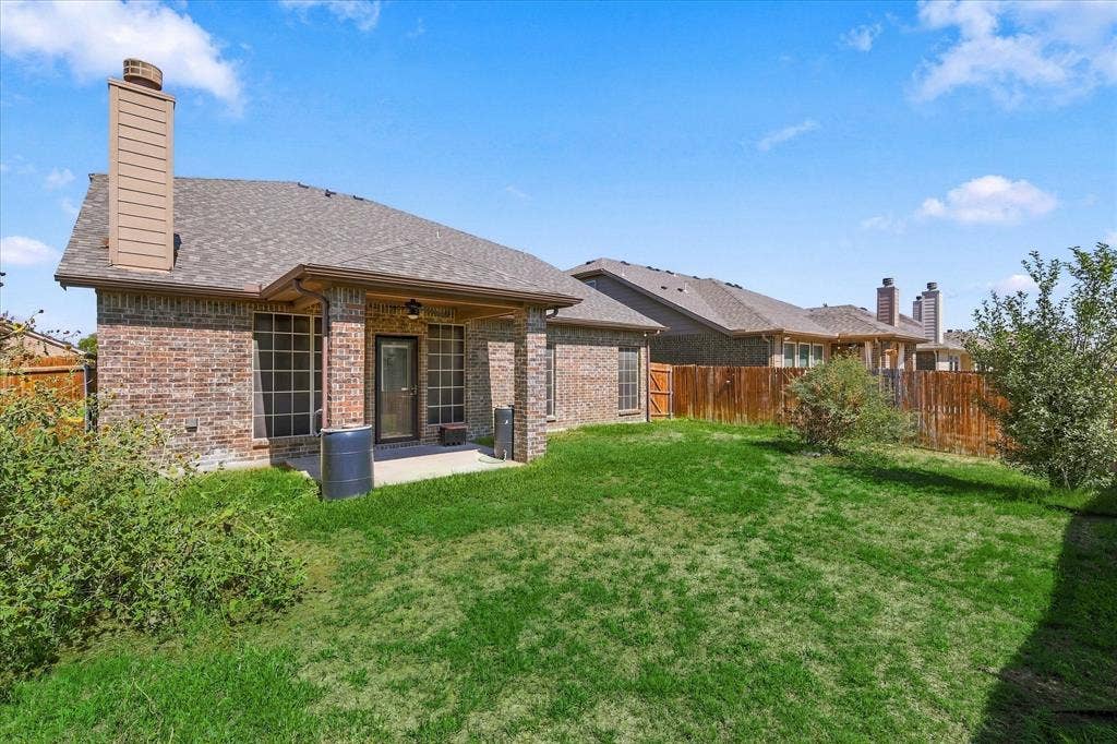 4716 Kendrick Peak Way, Fort Worth, TX 76244 Backyard featuring a brick exterior, covered patio, privacy fence, and manicured lawn