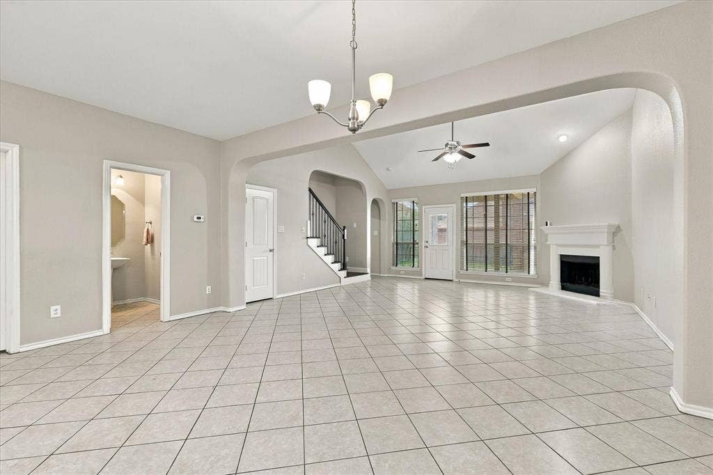 4716 Kendrick Peak Way, Fort Worth, TX 76244 Expansive tiled flooring throughout, vaulted ceiling, built-in fireplace, and a contemporary ceiling fan