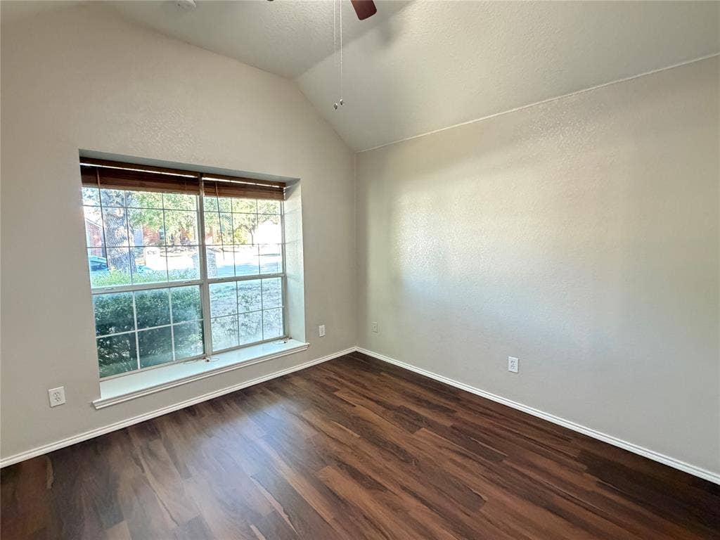 5932 Highcrest Drive, Watauga, TX 76148 Vaulted ceiling, wood-finish flooring, large window, ceiling fan, and neutral wall tones