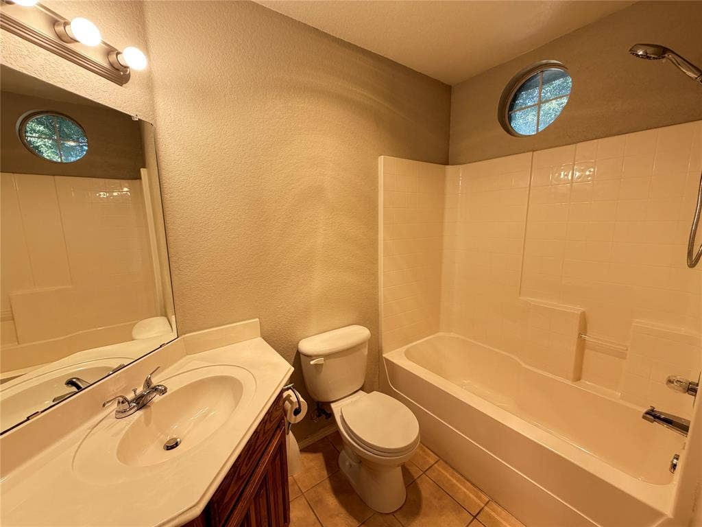 5932 Highcrest Drive, Watauga, TX 76148 Bathroom with a single vanity, integrated sink, and wood-finish cabinetry