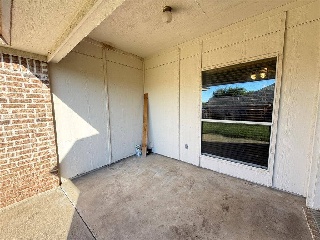 5932 Highcrest Drive, Watauga, TX 76148 Covered patio featuring a concrete slab and a brick exterior wall