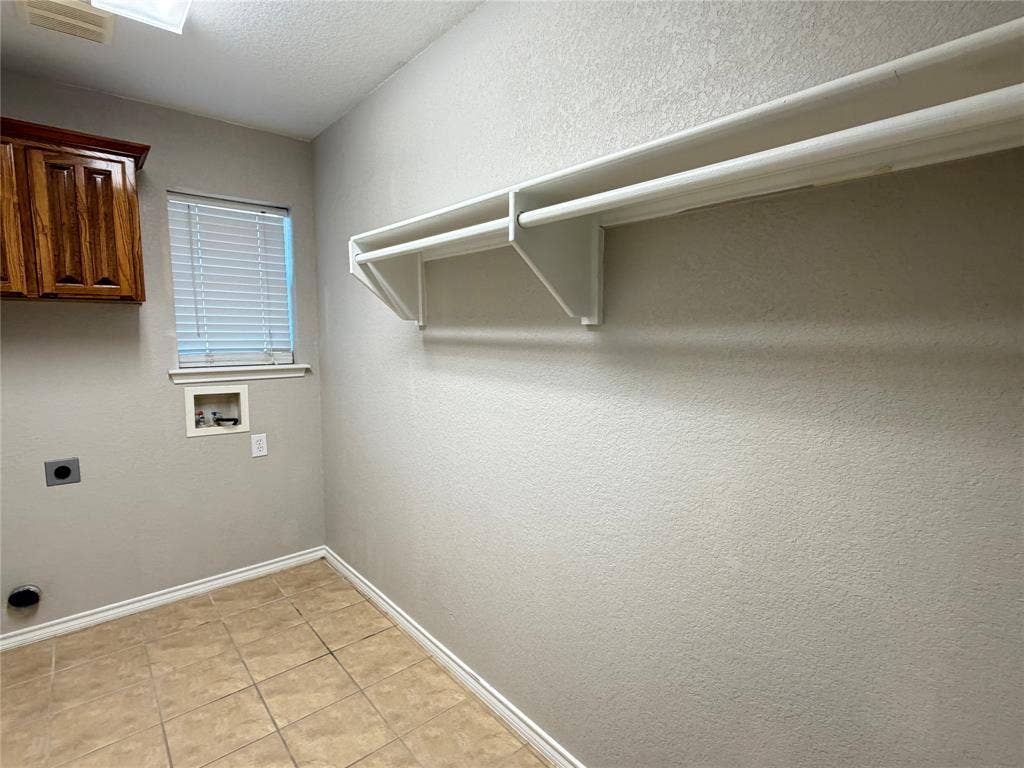 5932 Highcrest Drive, Watauga, TX 76148 Built-in storage shelving, wood-finish cabinetry, tiled flooring, and a window with blinds