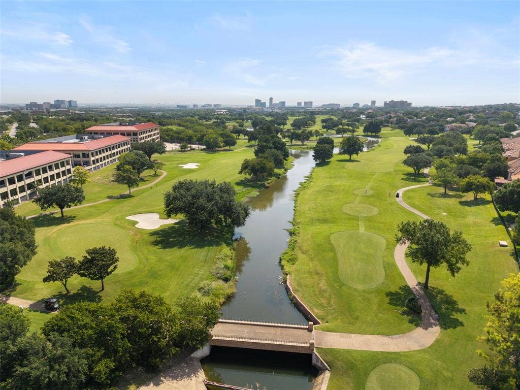 4414 Westminster Drive, Irving, TX 75038 Expansive green golf course with a water feature, mature trees, and a distant city skyline