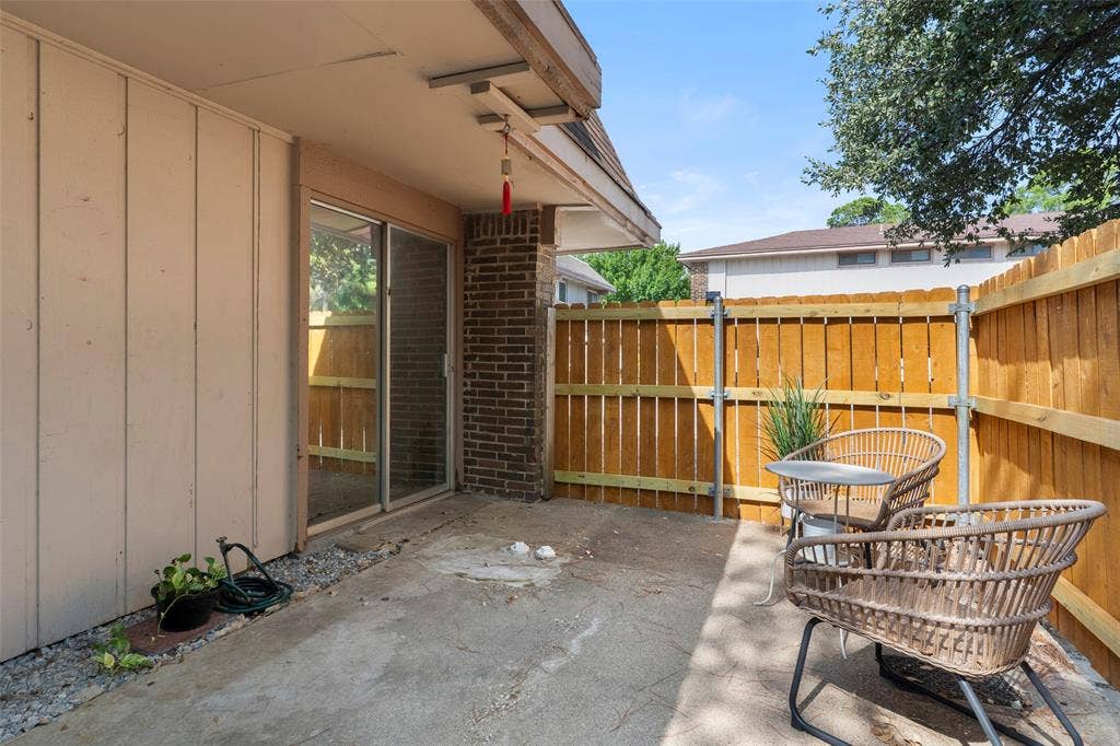 4414 Westminster Drive, Irving, TX 75038 Covered patio with concrete flooring and wood-finish fence enclosure