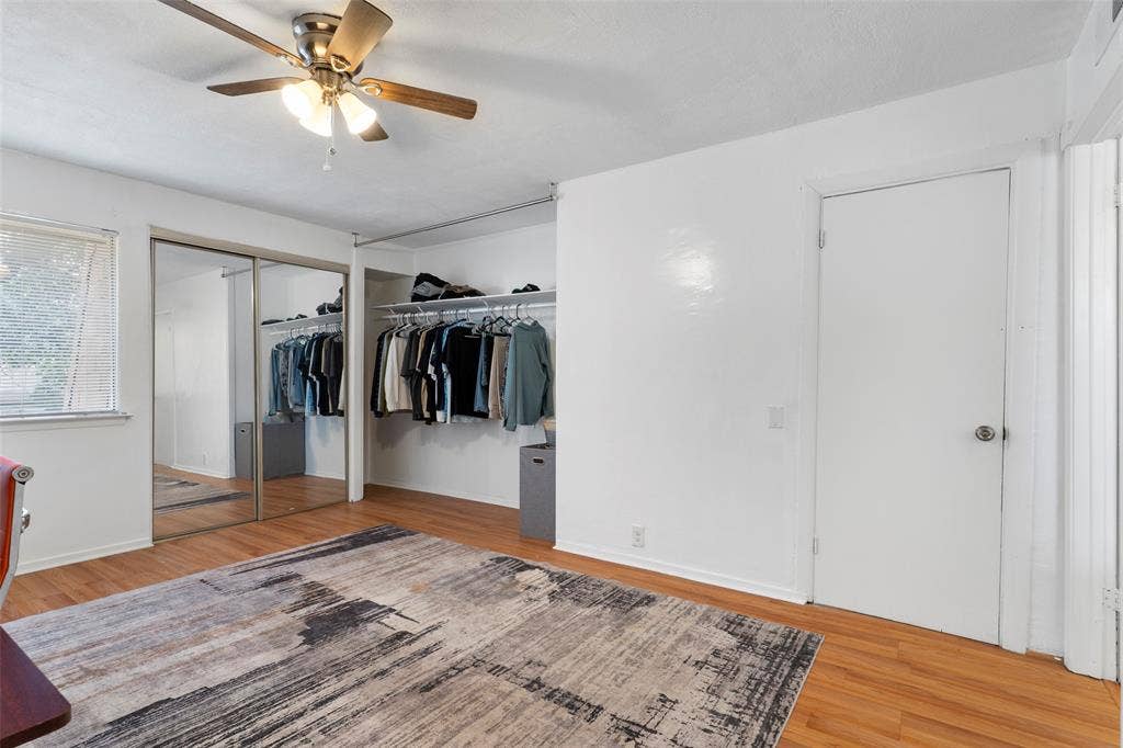 4414 Westminster Drive, Irving, TX 75038 Wood-finish flooring with a ceiling fan light fixture