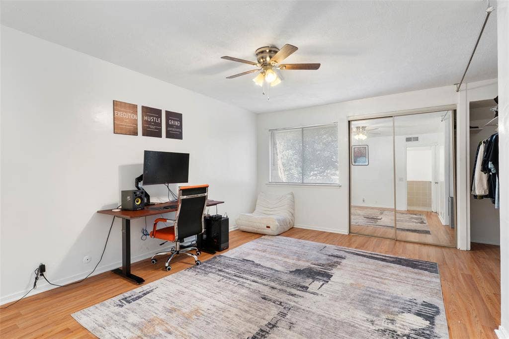 4414 Westminster Drive, Irving, TX 75038 Wood-finish flooring throughout, ceiling fan with light fixture, mirrored sliding closet doors, and single window