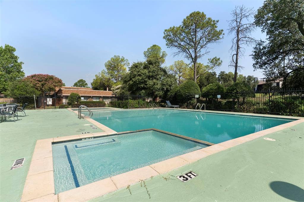 4414 Westminster Drive, Irving, TX 75038 Swimming pool and spa with a concrete deck, surrounded by mature trees and fencing