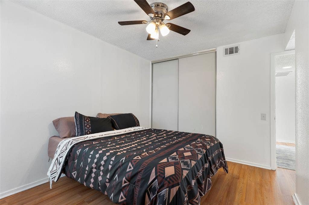 4414 Westminster Drive, Irving, TX 75038 Wood-finish flooring with a ceiling fan and overhead lighting