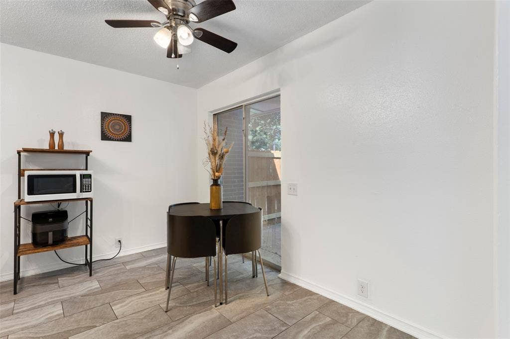 4414 Westminster Drive, Irving, TX 75038 Porcelain tile flooring, ceiling fan with integrated lighting, white walls, and a sliding glass door