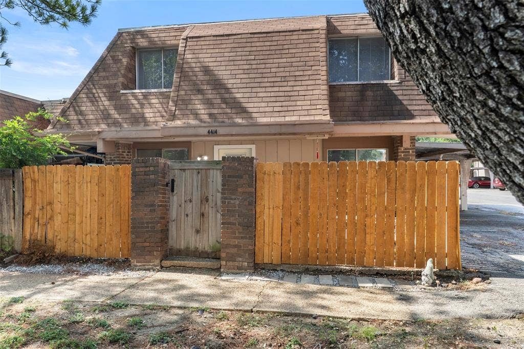 4414 Westminster Drive, Irving, TX 75038 Welcoming front entry featuring wooden privacy gates with brick and stone detailing