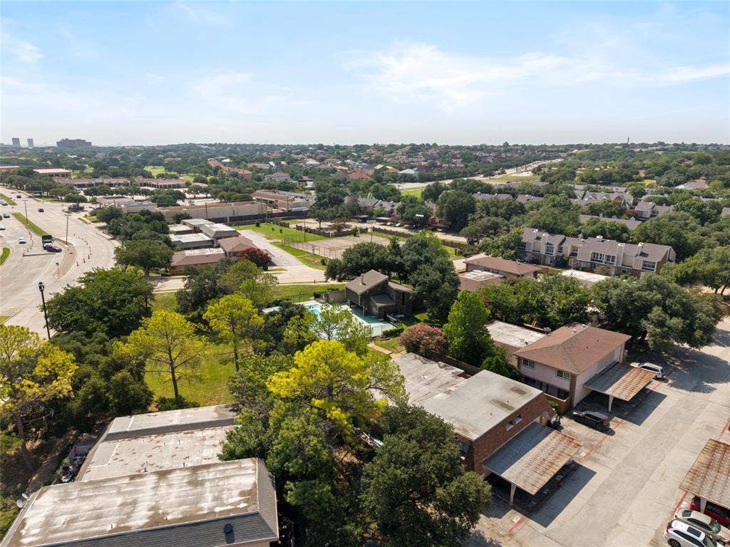 4414 Westminster Drive, Irving, TX 75038 Expansive neighborhood setting with established landscaping, multiple residential structures, and a prominent roadway