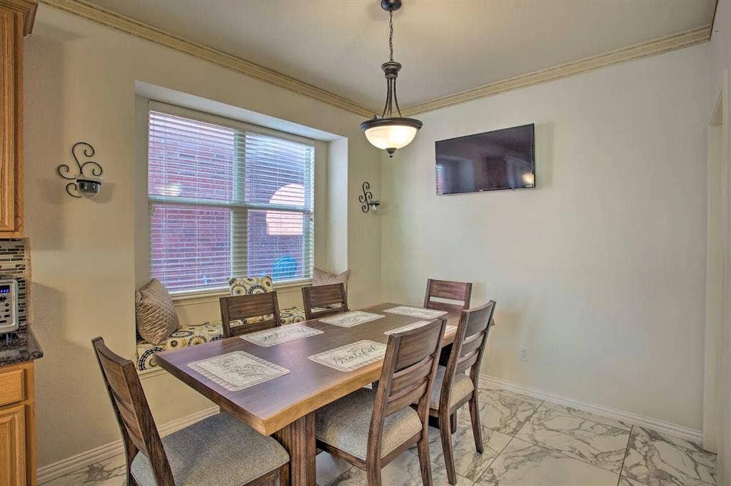 1950 Garrison Way, Garland, TX 75040 Dining space featuring a built-in window bench, crown molding, and a decorative pendant light fixture