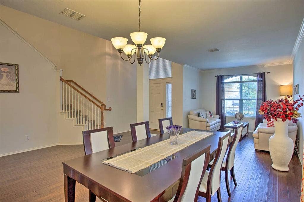 1950 Garrison Way, Garland, TX 75040 Warm wood-finish flooring extends through the dining area and living space