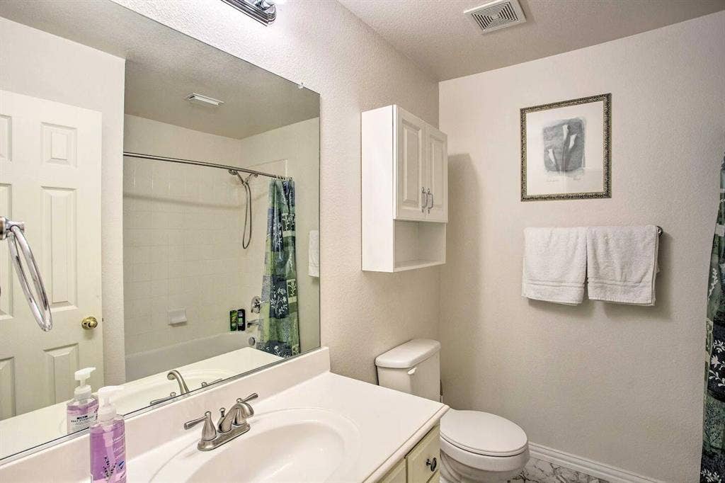 1950 Garrison Way, Garland, TX 75040 White vanity with an integrated sink, brushed nickel faucet, and extensive mirror