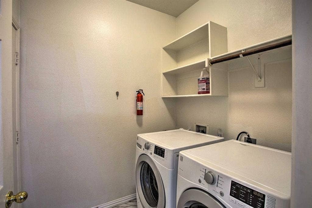 1950 Garrison Way, Garland, TX 75040 Laundry area featuring built-in shelving and a clothing rod