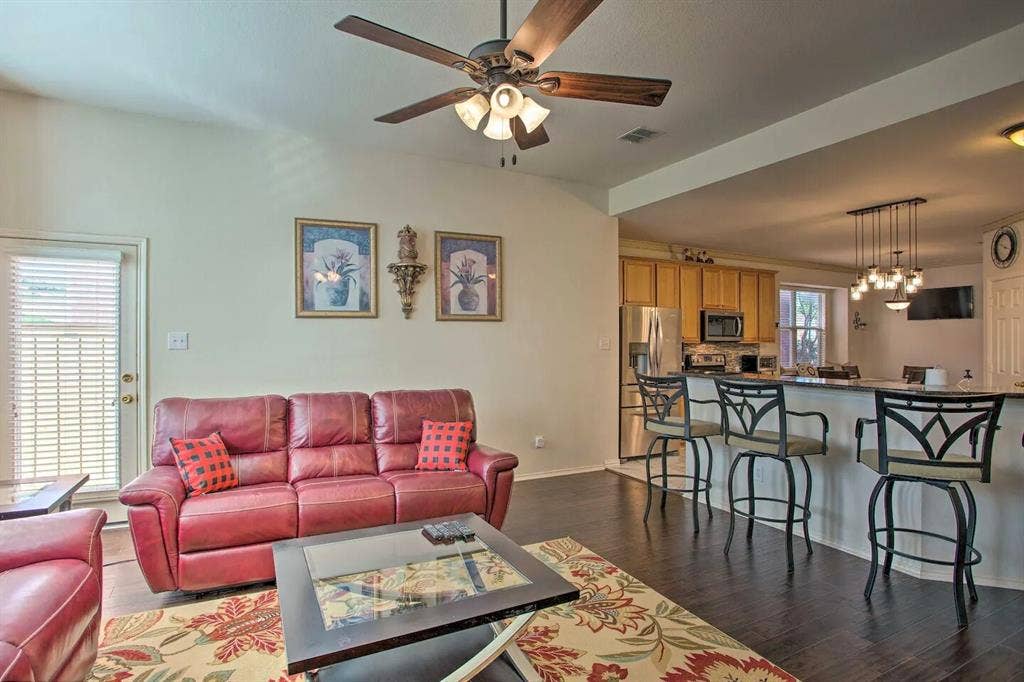 1950 Garrison Way, Garland, TX 75040 Vaulted ceiling with a ceiling fan, dark wood-finish flooring, and a breakfast bar with pendant lighting