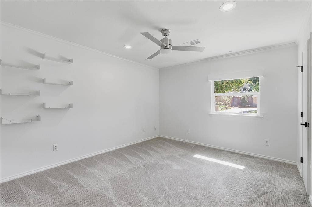 Recessed lighting, wall-mounted floating shelves, modern ceiling fan, and grey carpeting
