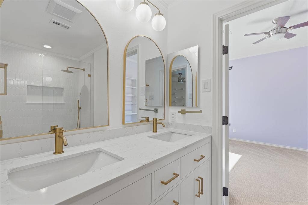 Dual vanity with integrated sinks and gold-tone fixtures