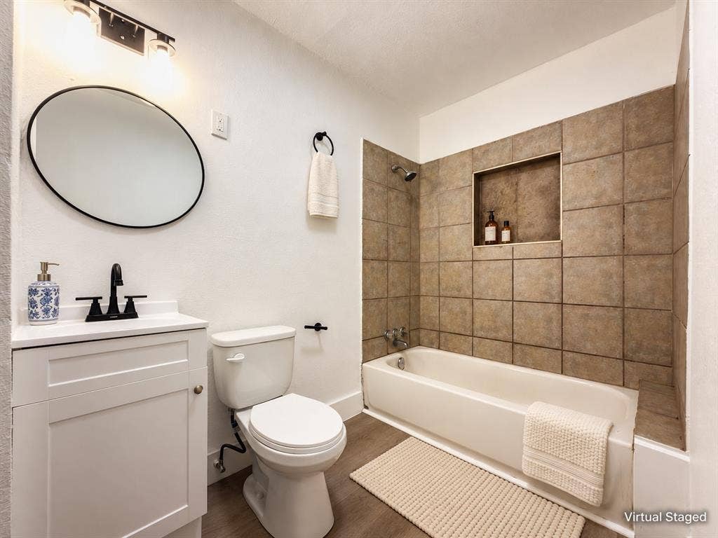 3709 N 22nd Street, Waco, TX 76708 White vanity with a single basin sink, matte black faucet, and an oval mirror