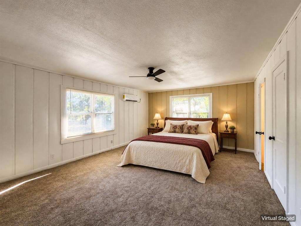 3709 N 22nd Street, Waco, TX 76708 Carpeted room with two windows, a ceiling fan, and white paneled walls