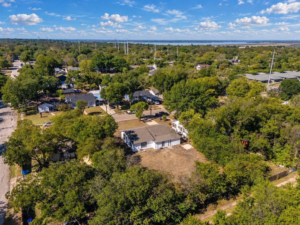 3709 N 22nd Street, Waco, TX 76708 Single-story residence with a gray shingle roof, positioned on a lot with mature trees