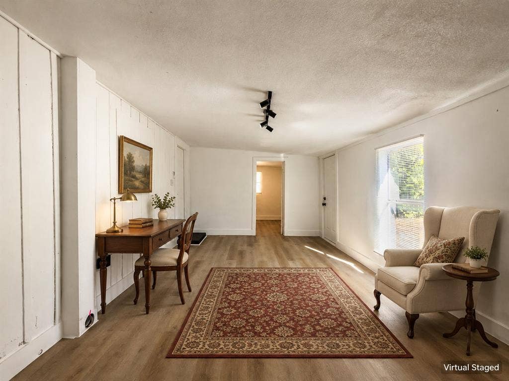 3709 N 22nd Street, Waco, TX 76708 Wood-finish flooring, white paneled wall, recessed window, track lighting, and white trim