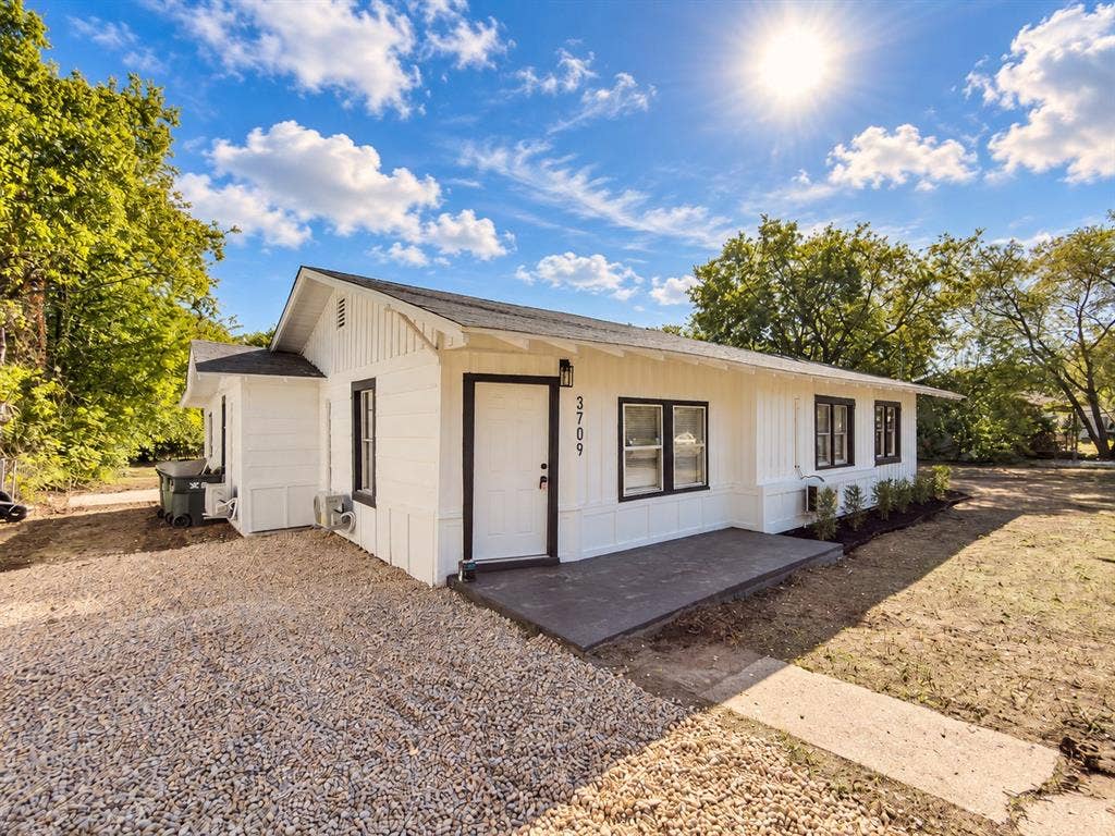 3709 N 22nd Street, Waco, TX 76708 White exterior siding with dark trim, featuring a dark shingle roof and a concrete entry porch