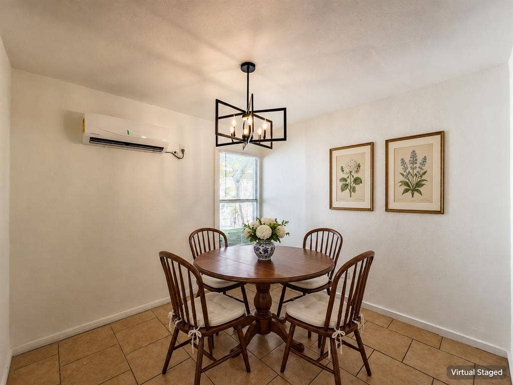 3709 N 22nd Street, Waco, TX 76708 Tile flooring, white walls, black-finish geometric chandelier, window with exterior views, and a wall-mounted mini-split AC unit