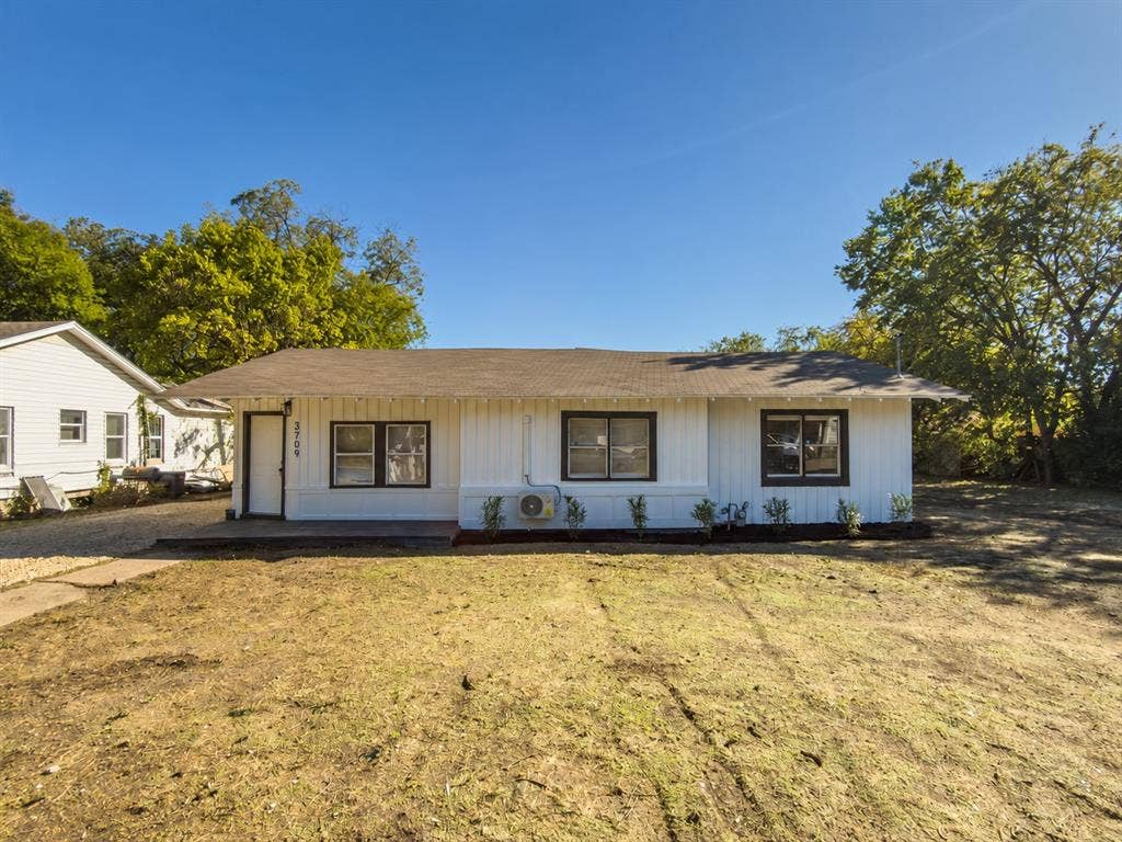 3709 N 22nd Street, Waco, TX 76708 Single-story residence featuring a clean white exterior with horizontal siding, multiple window openings, and a covered front entry