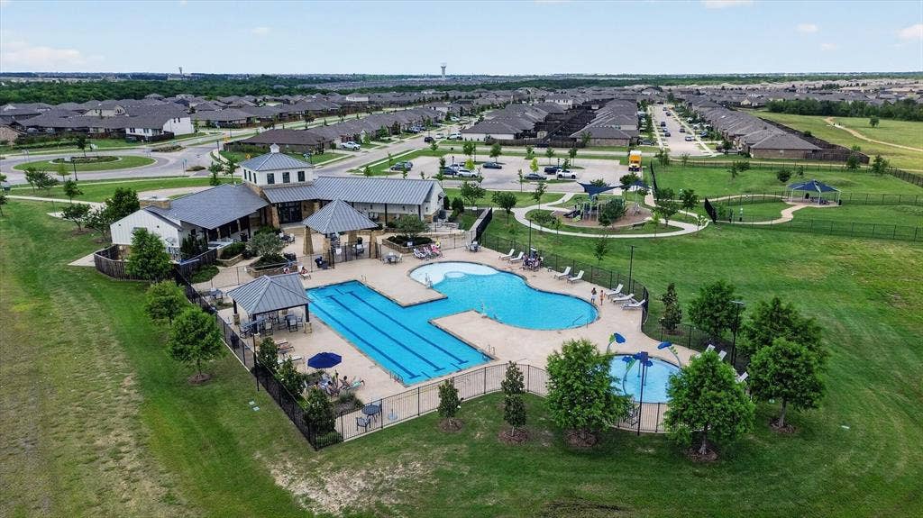 4562 Riverbank Road, Crandall, TX 75114 Community clubhouse with multiple swimming pools, including a lap pool and a splash pad