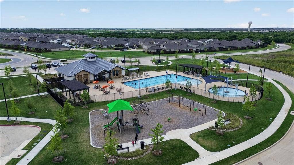4562 Riverbank Road, Crandall, TX 75114 Community amenity center featuring a swimming pool, separate splash pad, and playground structure