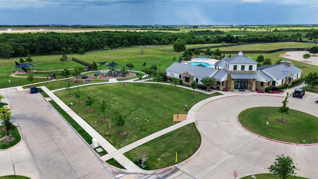 4562 Riverbank Road, Crandall, TX 75114 Community amenity building with stone and siding exterior, metal roof accents, and a large swimming pool