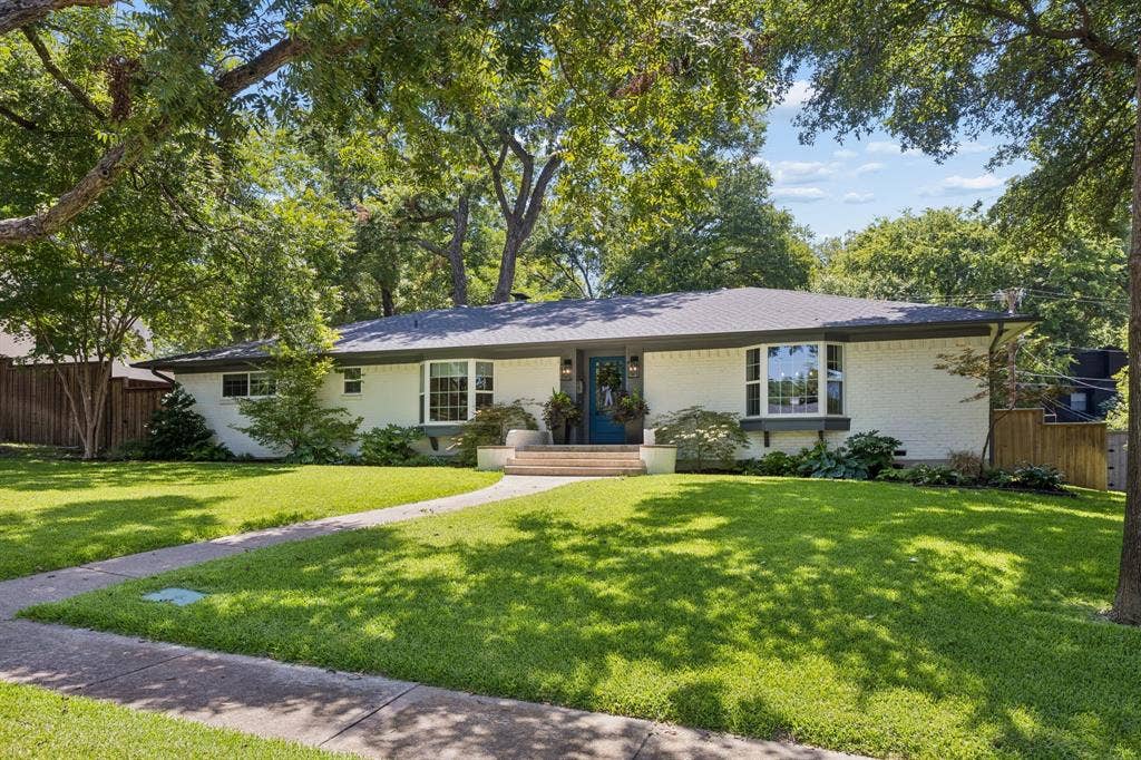 10428 Vinemont, Dallas, TX 75218 Ranch-style exterior with a dark shingle roof and white brick façade