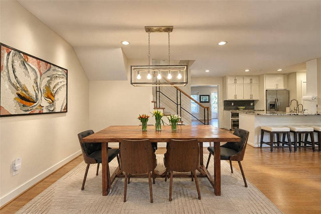 6866 Burwood Lane, Dallas, TX 75214 Open-concept dining area with wood-finish flooring, recessed lighting, and a linear chandelier