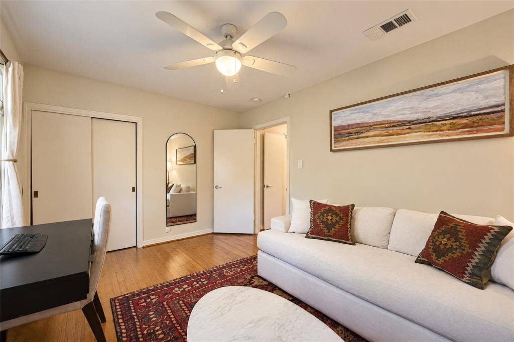 6866 Burwood Lane, Dallas, TX 75214 Wood-finish flooring, sliding closet doors, and an overhead ceiling fan with lighting