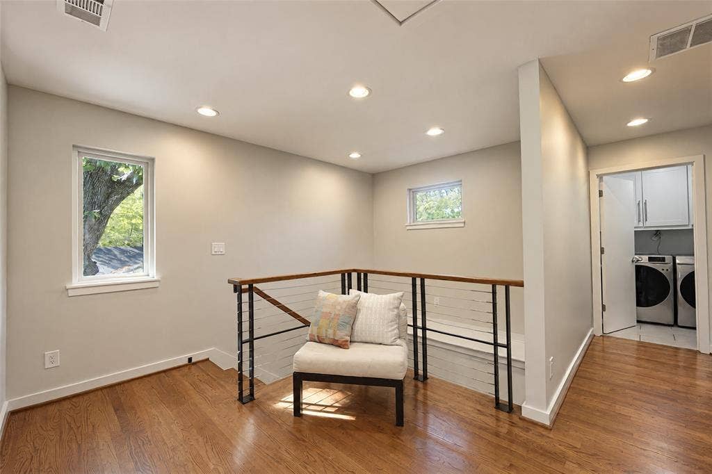 6866 Burwood Lane, Dallas, TX 75214 Hardwood flooring, recessed ceiling lighting, cable railing system, built-in laundry area with cabinetry, and multiple windows