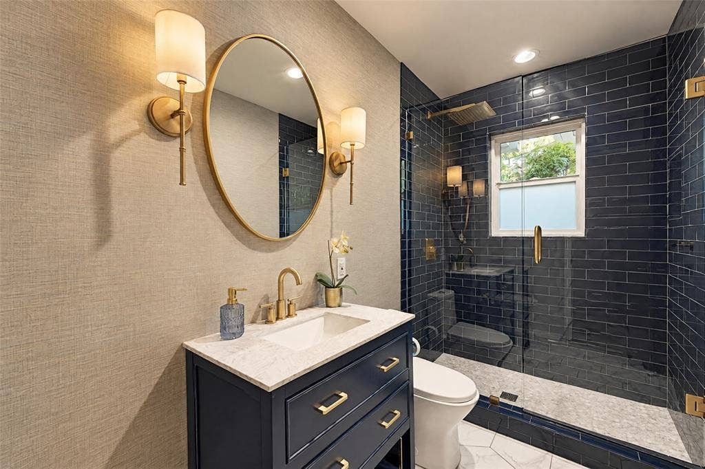 6866 Burwood Lane, Dallas, TX 75214 Vanity with a white countertop and gold-finish fixtures
