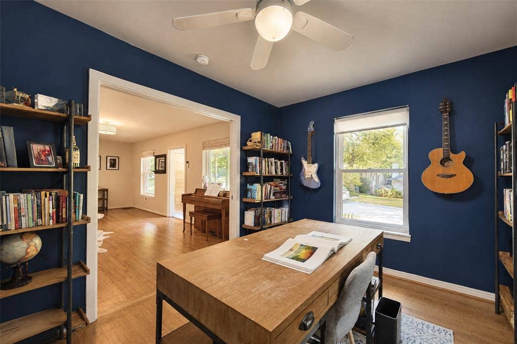6866 Burwood Lane, Dallas, TX 75214 Bright room with a ceiling fan, dual windows, and built-in shelving, featuring wood-finish flooring