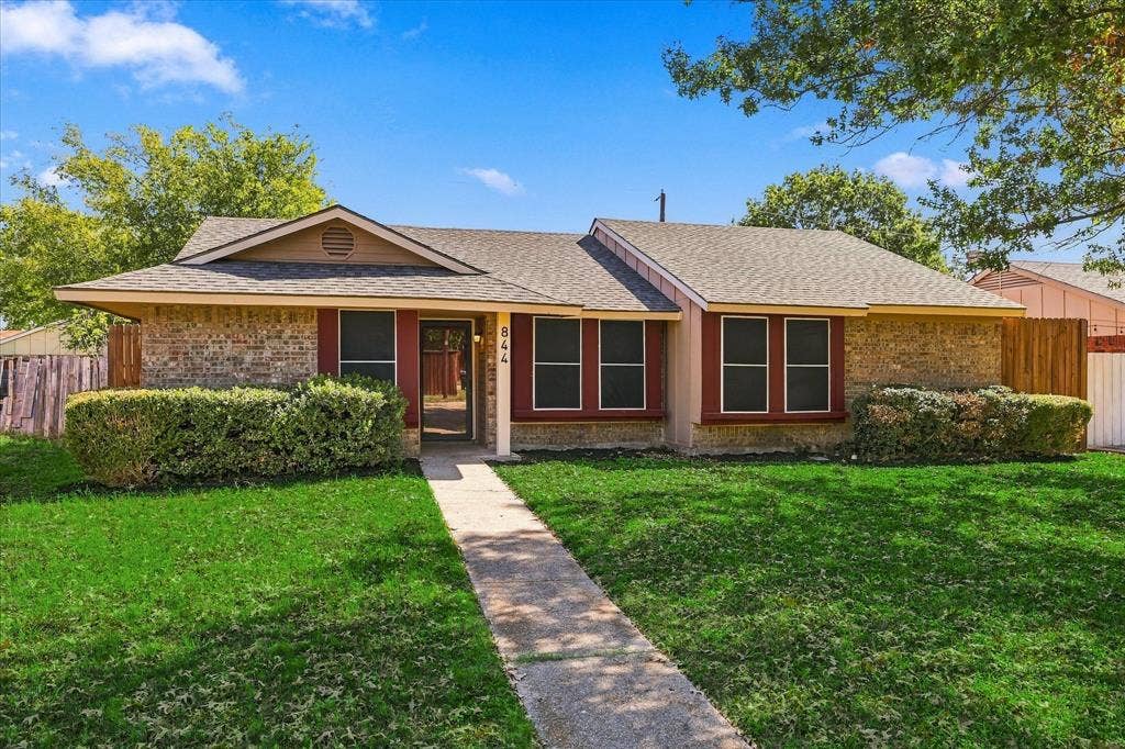 844 Woodrock Drive, Dallas, TX 75217 Brick and siding exterior with red window trim