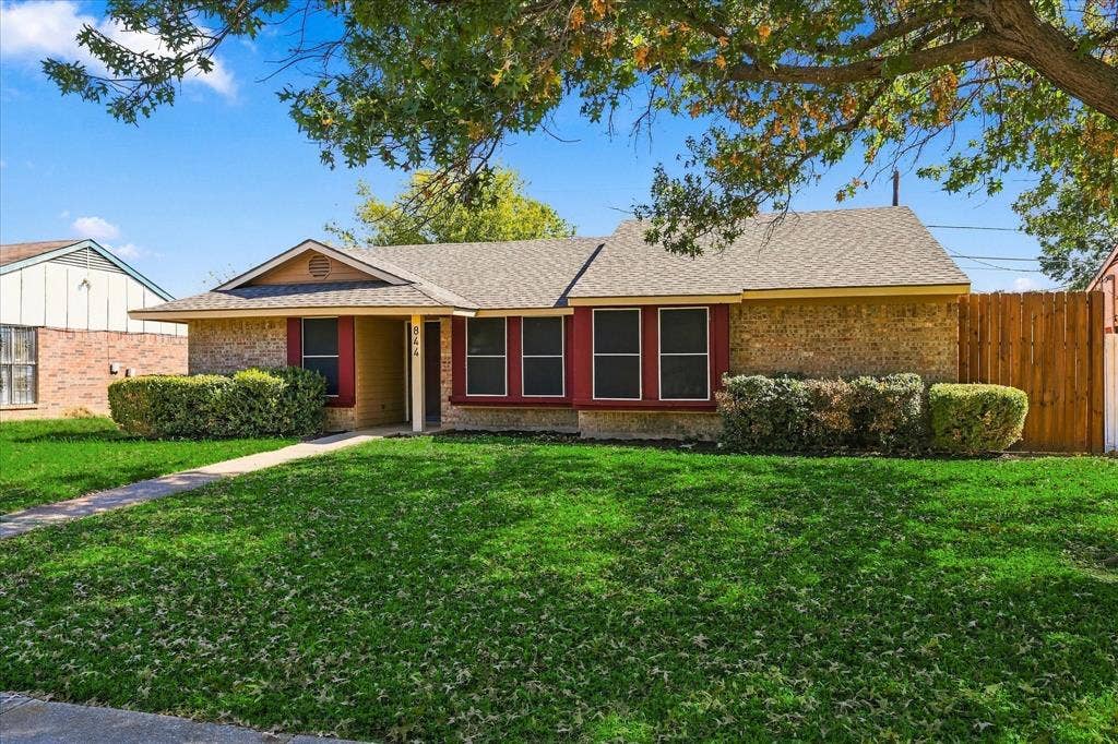 844 Woodrock Drive, Dallas, TX 75217 Brick exterior with a covered entry and a gabled roof