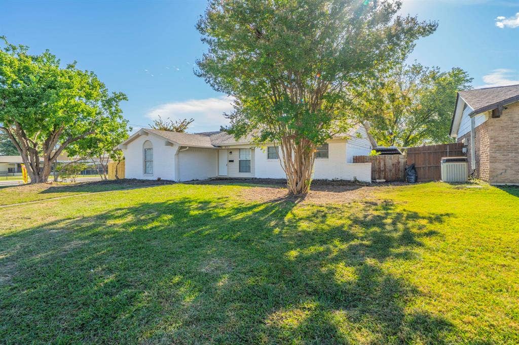802 Birchwood Drive, Garland, TX 75043 Single-story exterior with white siding and a light-colored roof